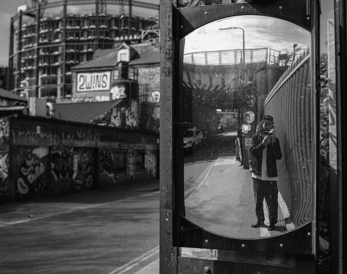 Seb Maher photographing himself in a convex street mirror